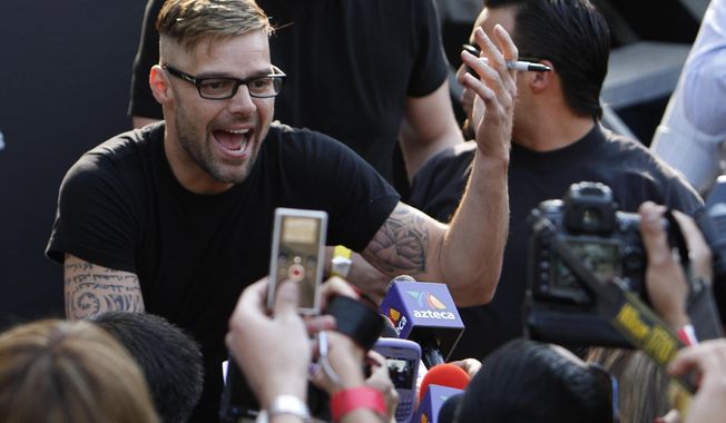 Puerto Rican pop star Ricky Martin signs autographs in Mexico City, April 5, 2011. A Puerto Rico court has “archived” a restraining order issued against the superstar, meaning the case is closed, a judicial spokesperson said Thursday, July 21, 2022.  (AP Photo/Marco Ugarte, File)