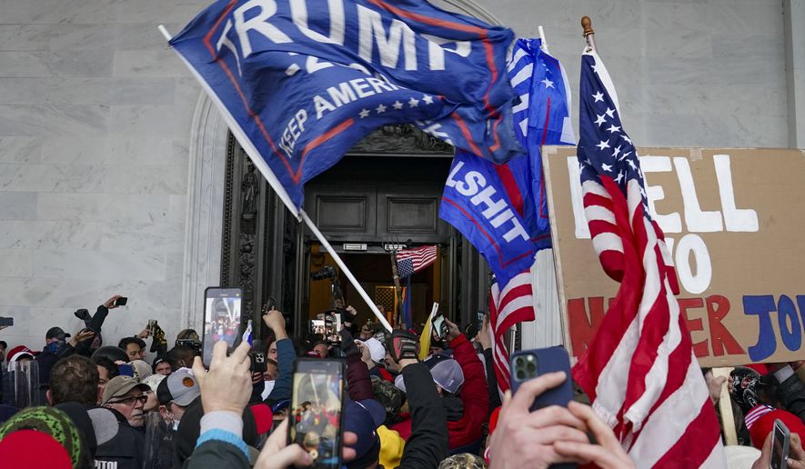 In this file photo, rioters break into the Capitol in Washington, on Jan. 6, 2021. (AP Photo/John Minchillo, File)  **FILE**