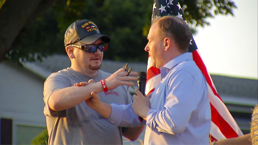 In this image taken from video provided by WHEC-TV, David Jakubonis, left, brandishes a sharp object as he attacks U.S. Rep. Lee Zeldin, right, as the Republican candidate for New York governor delivered a speech in Perinton, N.Y., Thursday, July 21, 2022. Jakubonis, 43, has been charged with attempted assault, arraigned and released, a Monroe County sheriff&#39;s spokesperson said. (WHEC-TV via AP)