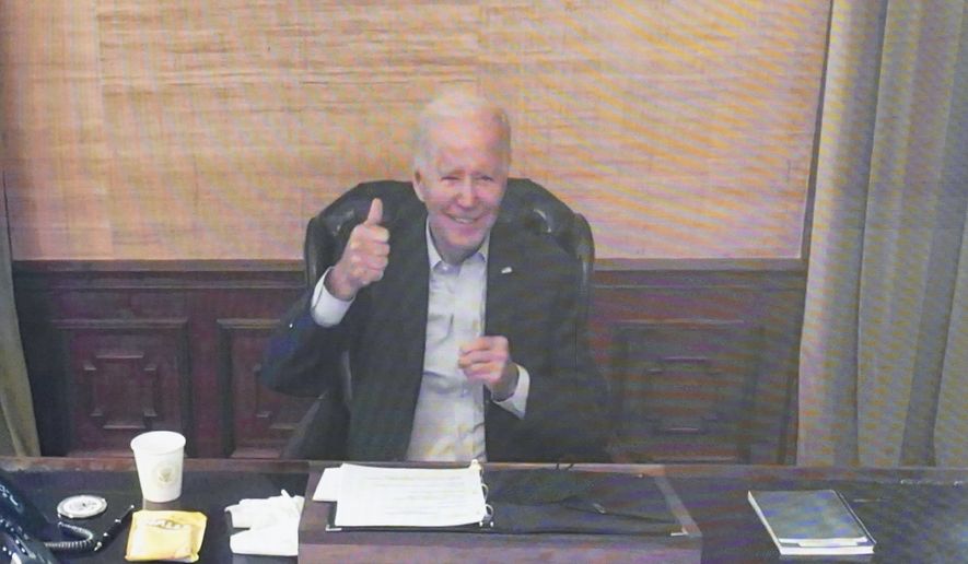 President Joe Biden gives a thumbs up after being asked by members of the media how he is feeling as he speaks virtually during a meeting with his economic team in the South Court Auditorium on the White House complex in Washington, Friday, July 22, 2022. (AP Photo/Andrew Harnik)