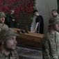 Soldiers of the Azov regiment pay their last respects to a serviceman killed in battle against Russian troops, in a city crematorium in Kyiv, Ukraine, Thursday, July 21, 2022. (AP Photo/Andrew Kravchenko)