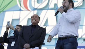 FILE - The League leader Matteo Salvini, right, is flanked by Silvio Berlusconi as he addresses a rally in Rome, on Oct. 19, 2019. The ink had barely dried on the presidential decree putting a premature end to Parliament after Italian Premier Mario Draghi&#39;s government collapsed, but politicians, including coalition allies who helped topple him, were already rushing into campaign mode on Friday. Perhaps the quickest was Matteo Salvini, the right-wing leader, who teamed up with former Premier Silvio Berlusconi to desert a confidence vote that Draghi sought this week to revive his struggling 17-month-old coalition, (AP Photo/Andrew Medichini)
