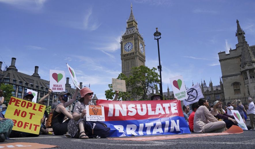 Members of environmental groups including Just Stop Oil, the Peace and Justice Project and Insulate Britain take part in a mass protest in Parliament Square, London. (Jonathan Brady/PA via AP)