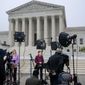 FILE - Television news crews stand at the Supreme Court, May 3, 2022, in Washington, following news report by Politico that a draft opinion suggests the justices could be poised to overturn the landmark 1973 Roe v. Wade case that legalized abortion nationwide. (AP Photo/J. Scott Applewhite)