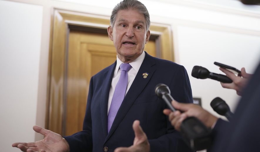 Sen. Joe Manchin, D-W.Va., is met by reporters outside the hearing room where he chairs the Senate Committee on Energy and Natural Resources, at the Capitol in Washington, July 21, 2022. Manchin has been an obstacle for Biden's climate change plans, a reflection of his outsized influence at a time when Democrats hold the narrowest of margins in the U.S. Senate. (AP Photo/J. Scott Applewhite, File)