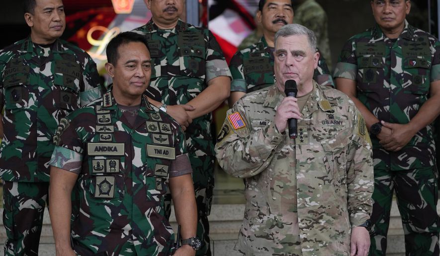 U.S. Chairman of the Joint Chiefs of Staff Gen. Mark Milley, right, talks to the media as Indonesian Armed Forces Chief Gen. Andika Perkasa, left, listens, after their meeting at Indonesian military headquarters in Jakarta, Indonesia, Sunday, July 24, 2022. The Chinese military has become significantly more aggressive and dangerous over the past five years, the top U.S. military officer said during a trip to the Indo-Pacific that included a stop Sunday in Indonesia. (AP Photo/Achmad Ibrahim)