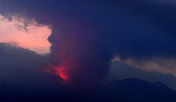 This long exposure image shows the eruption of volcano Sakurajima Sunday night, July 24, 2022, in the view from Tarumizu city, Japan&#39;s southern prefecture of Kagoshima. Japan’s Meteorological Agency said a volcano on Japan’s southern main island of Kyushu erupted Sunday night, spewing ash and volcanic rocks, but there were no immediate reports of damage or injuries in nearby towns. (Kyodo News via AP)