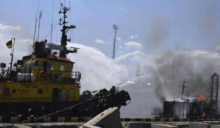In this photo provided by the Odesa City Hall Press Office, firefighters put out a fire in the port after a Russian missiles attack in Odesa, Ukraine, Saturday, June 5, 2022. Russian missiles have struck Ukraine’s Black Sea port of Odesa just hours after Moscow and Kyiv signed deals to allow grain exports to resume from there. (Odesa City Hall Press Office via AP)