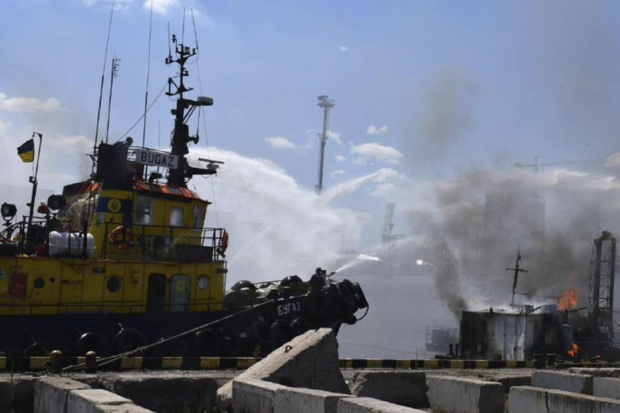 In this photo provided by the Odesa City Hall Press Office, firefighters put out a fire in the port after a Russian missiles attack in Odesa, Ukraine, Saturday, June 5, 2022. Russian missiles have struck Ukraine’s Black Sea port of Odesa just hours after Moscow and Kyiv signed deals to allow grain exports to resume from there. (Odesa City Hall Press Office via AP)