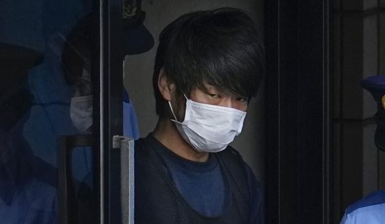 Tetsuya Yamagami, the alleged assassin of Japan’s former Prime Minister Shinzo Abe, gets out of a police station in Nara, western Japan, on July 10, 2022, on his way to local prosecutors&#39; office.  The suspect will be detained until late November for mental evaluation so prosecutors can determine whether to formally press charges and sent him to trial for murder, officials said Monday.(Nobuki Ito/Kyodo News via AP, File)