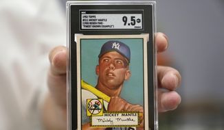 A Mickey Mantle baseball card is displayed at Heritage Auctions in Dallas, Thursday, July 21, 2022. The mint-condition Mantle card is expected to sell well into the millions when bidding ends at the end of the month. (AP Photo/LM Otero) **FILE**