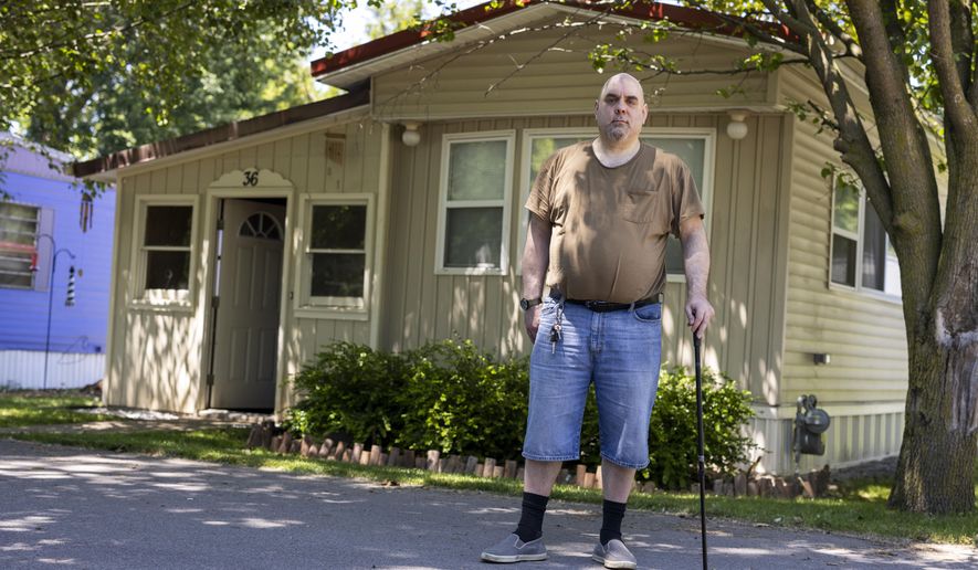 Jeremy Ward poses for a portrait in front of his home in the Ridgeview Homes mobile home community in Lockport, N.Y., June 23, 2022. Ward is one of the residents at Ridgeview participating in a rent strike after new owners of the park announced they were raising rents by 6 percent. &amp;quot;I moved here because it&#39;s basically the most affordable living,&amp;quot; said Ward, who is disabled and living off of a fixed income. The plight of residents at Ridgeview is playing out nationwide as institutional investors, led by private equity firms and real estate trusts and sometimes funded by pension funds, swoop in to buy mobile home parks. (AP Photo/Lauren Petracca)