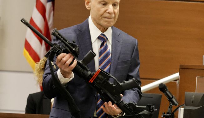 Assistant State Attorney Mike Satz, checks into evidence the weapon used in the MSD shooting during the penalty phase of shooter Nikolas Cruz at the Broward County Courthouse in Fort Lauderdale on Monday, July 25, 2022. Cruz previously plead guilty to all 17 counts of premeditated murder and 17 counts of attempted murder in the 2018 shootings. (Carline Jean/ Florida Sun Sentinel via AP, Pool)