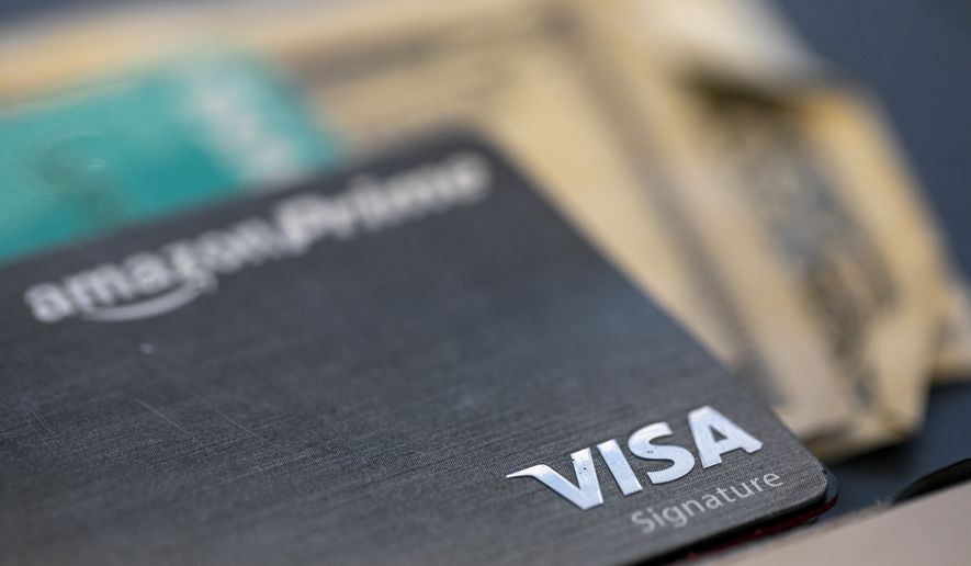 This Aug. 11, 2019, photo shows a Visa logo on a credit card in New Orleans. (AP Photo/Jenny Kane) **FILE**