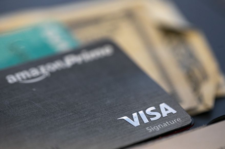 This Aug. 11, 2019, photo shows a Visa logo on a credit card in New Orleans. (AP Photo/Jenny Kane) **FILE**