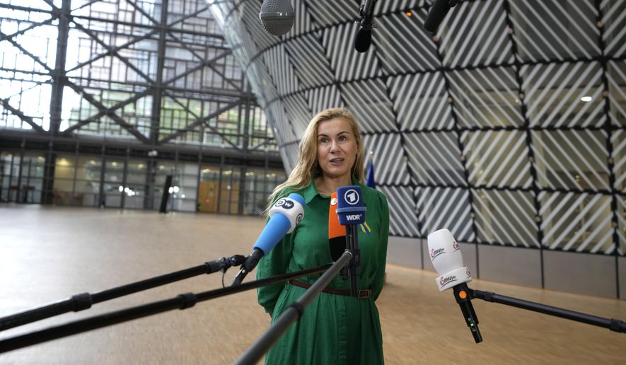 European Commissioner for Energy Kadri Simson speaks with the media as she arrives for an emergency meeting of EU energy ministers in Brussels on Tuesday, July 26, 2022. European Union governments Tuesday neared an agreement on rationing natural gas this winter to protect against any further supply cuts by Russia. (AP Photo/Virginia Mayo)