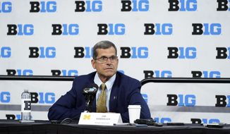 Michigan head coach Jim Harbaugh talks to reporters during an NCAA college football news conference at the Big Ten Conference media days, at Lucas Oil Stadium, Tuesday, July 26, 2022, in Indianapolis. (AP Photo/Darron Cummings)