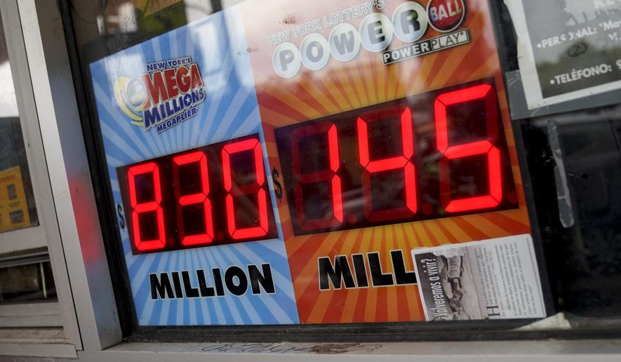 The Mega Millions lottery jackpot is advertised outside a smoke shop in the Bushwick neighborhood in the Brooklyn borough of New York, Tuesday, July 26, 2022. The payoff for Tuesday night's drawing is an estimated $810 million, the nation's fourth-largest jackpot. (AP Photo/John Minchillo)