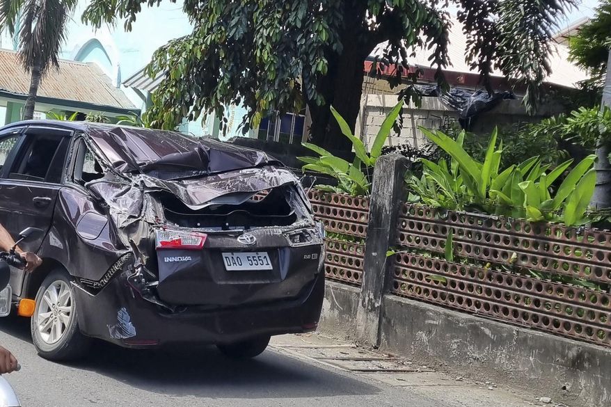 A damaged car is seen along a road after a strong quake hit Bangued, Abra province, northern Philippines on Wednesday July 27, 2022. A strong earthquake shook the northern Philippines on Wednesday, causing some damage and prompting people to flee buildings in the capital. Officials said no casualties were immediately reported. (AP Photo/Raphiel Alzate)