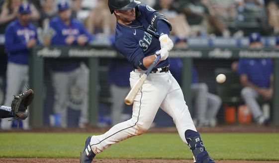 Seattle Mariners&#39; Ty France hits a solo home run against the Texas Rangers during the fifth inning of a baseball game, Monday, July 25, 2022, in Seattle. (AP Photo/Ted S. Warren)
