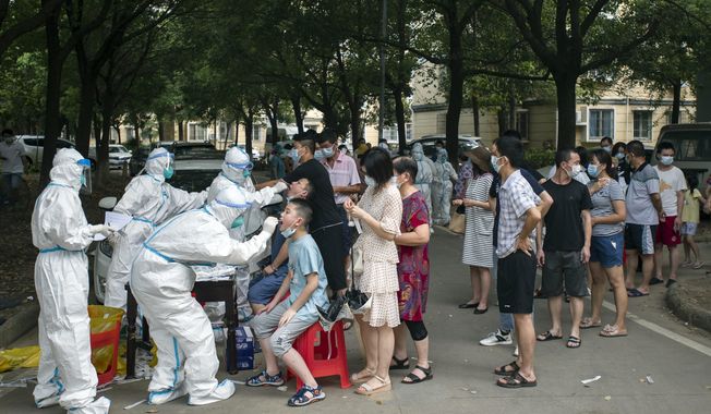 Residents line up to be tested for COVID-19 in Wuhan, central China&#x27;s Hubei province on Aug. 3, 2021. (Chinatopix via AP, File)