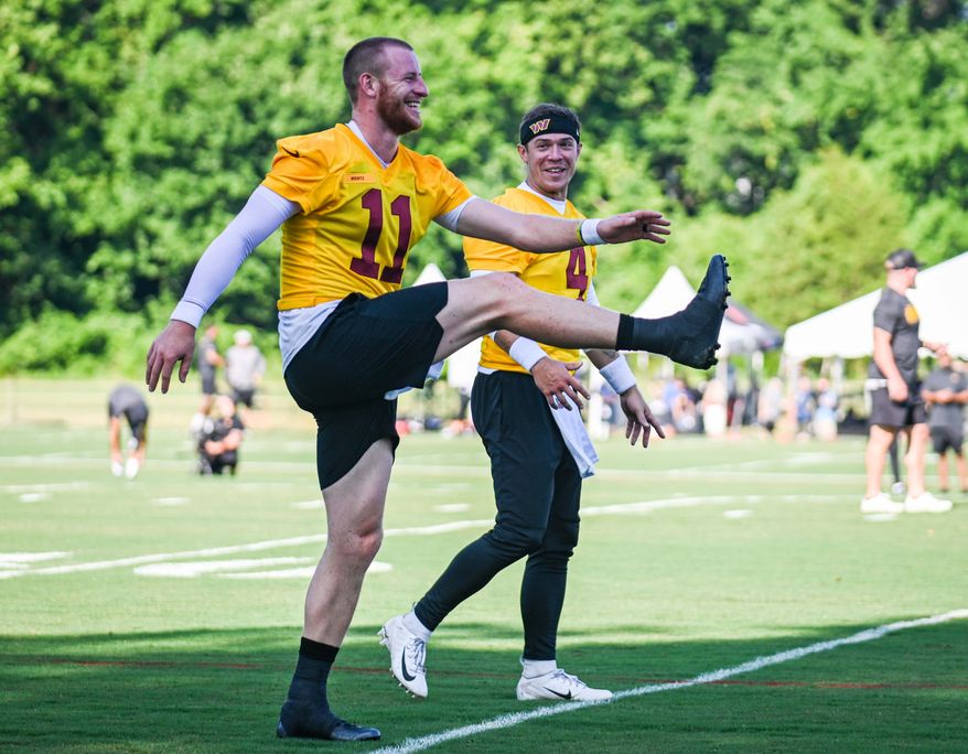 Carson Wentz (11) and Taylor Heinecke (4) have a laugh before practice from Washington Commanders training camp at The Park, Ashburn, VA, July 27th, 2022. (All-Pro Reels / Joe Glorioso)