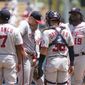 Washington Nationals starting pitcher Patrick Corbin, second from left, gets a conference on the mound with teammates during the first inning of a baseball game against the Los Angeles Dodgers, Wednesday, July 27, 2022, in Los Angeles. (AP Photo/Marcio Jose Sanchez)