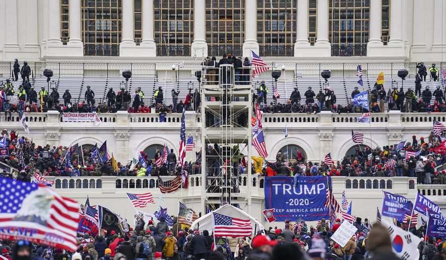 Supporters loyal to President Donald Trump breach the U.S. Capitol in Washington, Jan. 6, 2021. (AP Photo/John Minchillo, File)