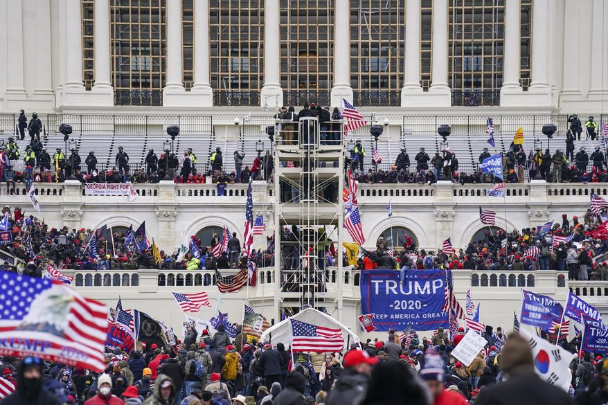 Supporters loyal to President Donald Trump breach the U.S. Capitol in Washington, Jan. 6, 2021. (AP Photo/John Minchillo, File)