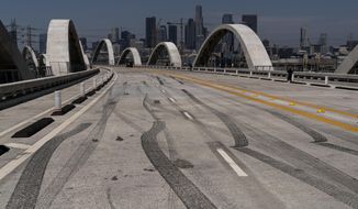Some skid marks are seen on the 6th Street Viaduct in Los Angeles, Wednesday, July 27, 2022. The newest bridge in Los Angeles, a $588-million architectural marvel with views of the downtown skyline, opened to great fanfare on July 10. It has already been closed, to great dismay, several times since then amid chaos and collisions. (AP Photo/Jae C. Hong)