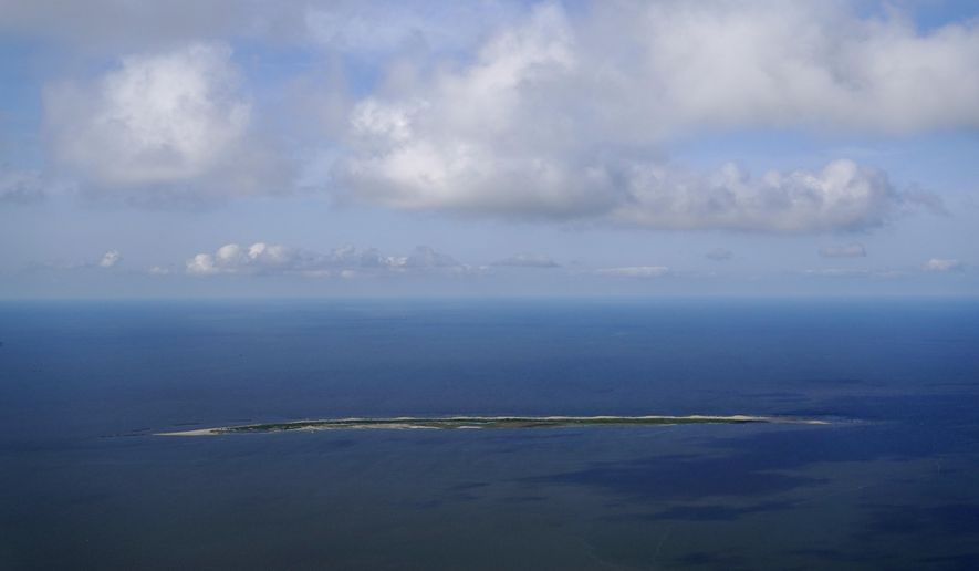 Raccoon Island, a Gulf of Mexico barrier island that is a nesting ground for brown pelicans, terns, seagulls and other birds, is seen form the leeward side in this aerial photo in Chauvin, La., Tuesday, May 17, 2022. A dozen years ago, there were 15 low-lying islands with nesting colonies of Louisiana’s state bird. But today, just six islands in the state harbor brown pelican nests — the rest have disappeared under water. (AP Photo/Gerald Herbert)