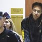 WNBA star and two-time Olympic gold medalist Brittney Griner is escorted to a courtroom for a hearing, in Khimki just outside Moscow, Russia, Monday, July 25, 2022. American basketball star Brittney Griner returns Tuesday to a Russian courtroom for her drawn-out trial on drug charges that could bring her 10 years in prison if convicted. (Evgenia Novozhenina/Pool Photo via AP)