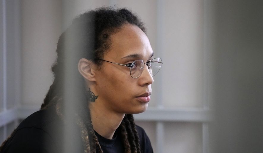 WNBA star and two-time Olympic gold medalist Brittney Griner sits in a cage at a courtroom prior to a hearing, in Khimki just outside Moscow, Russia, Wednesday, July 27, 2022. (AP Photo/Alexander Zemlianichenko, Pool)