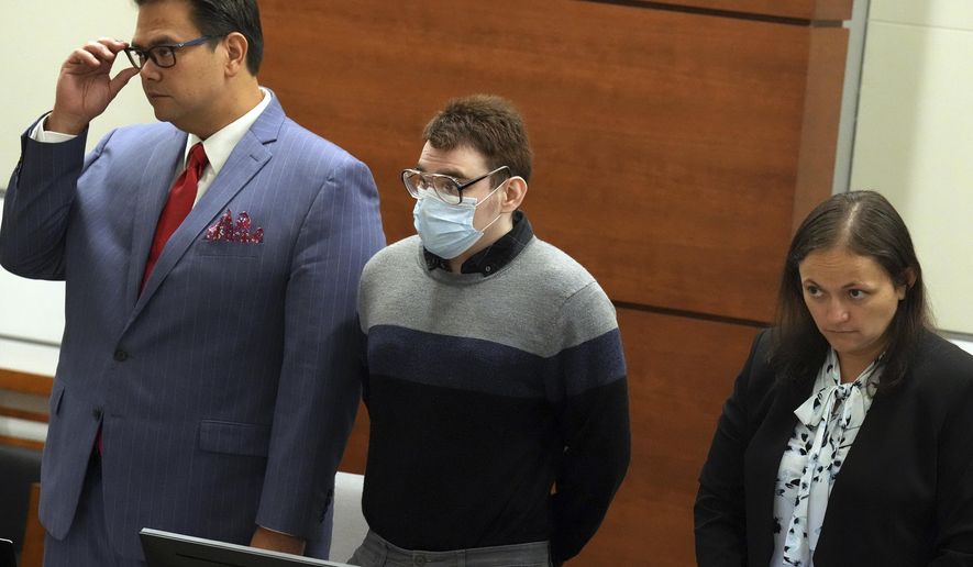 Marjory Stoneman Douglas High School shooter Nikolas Cruz stands with Chief Assistant Public Defender David Wheeler and sentence mitigation specialist Kate O'Shea, during the penalty phase of Cruz's trial at the Broward County Courthouse in Fort Lauderdale on Wednesday, July 27, 2022. Cruz previously plead guilty to all 17 counts of premeditated murder and 17 counts of attempted murder in the 2018 shootings. (Mike Stocker/South Florida Sun Sentinel via AP, Pool)