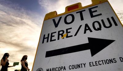 Voters deliver their ballots to a polling station on Nov. 3, 2020, in Tempe, Ariz. (AP Photo/Matt York, File)