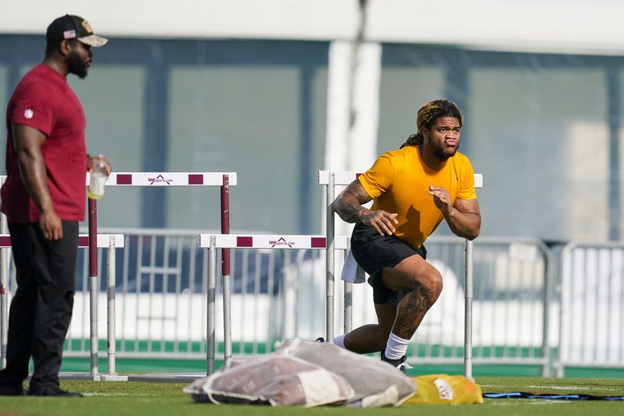 Washington Commanders defensive end Chase Young works during practice at the team&#x27;s NFL football training facility, Thursday, July 28, 2022 in Ashburn, Va. (AP Photo/Alex Brandon)