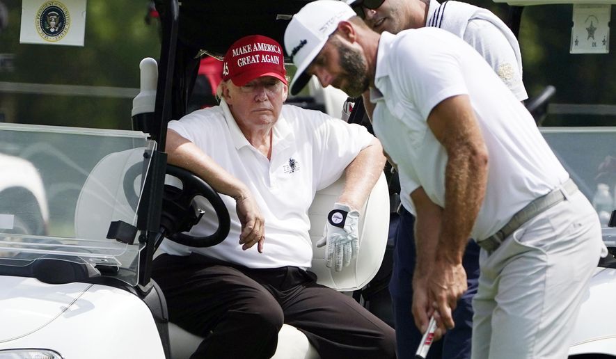 Former President Donald Trump sits in a golf cart as he watches Dustin Johnson putt during the pro-am round of the Bedminster Invitational LIV Golf tournament in Bedminster, N.J., Thursday, July 28, 2022. (AP Photo/Seth Wenig)