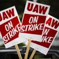 Signs are posted during a demonstration outside a General Motors facility in Langhorne, Pa., Sept. 16, 2019. The United Auto Workers union is increasing the strike pay it offers workers who walk off the job for the second time this year in 2022, following a spate of strikes amid the ongoing worker shortages nationwide. (AP Photo/Matt Rourke, File)