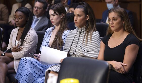 United States gymnasts from left, Simone Biles, McKayla Maroney, Aly Raisman and Maggie Nichols, arrive to testify during a Senate Judiciary hearing about the Inspector General&#39;s report on the FBI&#39;s handling of the Larry Nassar investigation on Capitol Hill, Sept. 15, 2021, in Washington. The FBI has reached out to attorneys representing Olympic gold medalist Simone Biles and other women who say they were sexually assaulted by Larry Nassar to begin settlement talks in the $1 billion claim they brought against the federal government, according to three people familiar with the matter. (Saul Loeb/Pool via AP, File)