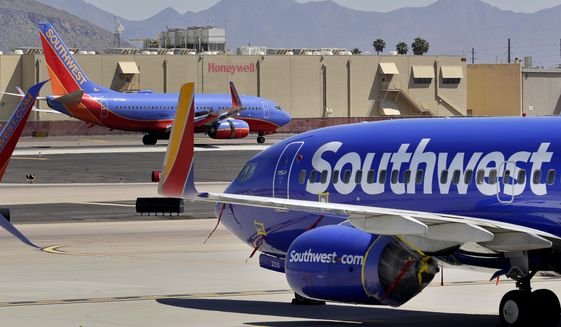 Southwest Airlines jets are stored at Sky Harbor International Airport in Phoenix, Tuesday, April 28, 2020. (AP Photo/Matt York, File)