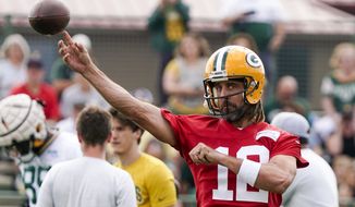 Green Bay Packers&#39; Aaron Rodgers runs a drill at the NFL football team&#39;s practice field Wednesday, July 27, 2022, in Green Bay, Wis. (AP Photo/Morry Gash)