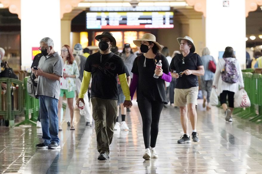 Travelers wear masks inside Union Station Thursday, July 28, 2022, in Los Angeles. Health officials in Los Angeles County are debating a decision to reinstate an indoor mask mandate Thursday. (AP Photo/Marcio Jose Sanchez)