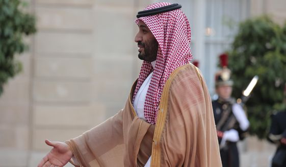 Saudi Crown Prince Mohammed bin Salman reaches out to shake hands with French President Emmanuel Macron as he arrives for a dinner at the Elysee Palace in Paris, Thursday July 28, 2022. French President Emmanuel Macron welcomed Saudi Crown Prince Mohammed bin Salman to his presidential palace and offer him dinner, marking another step in the Saudi leader&#39;s diplomatic rehabilitation less than four years after the killing of writer and critic Jamal Khashoggi. (AP Photo/Lewis Joly)