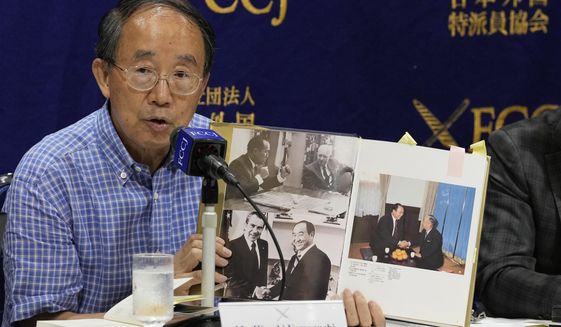 Legal expert Hiroshi Yamaguchi, holding a book related to the Unification Church, speaks during a news conference on the church and its activities at the Foreign Correspondents&#39; Club of Japan in Tokyo, Friday, July 29, 2022. A group of lawyers said Friday that the alleged assassin of former Prime Minister Shinzo Abe was one of many victims of the Unification Church, which has long cultivated ties with high-level Japanese politicians. (AP Photo/Shuji Kajiyama)
