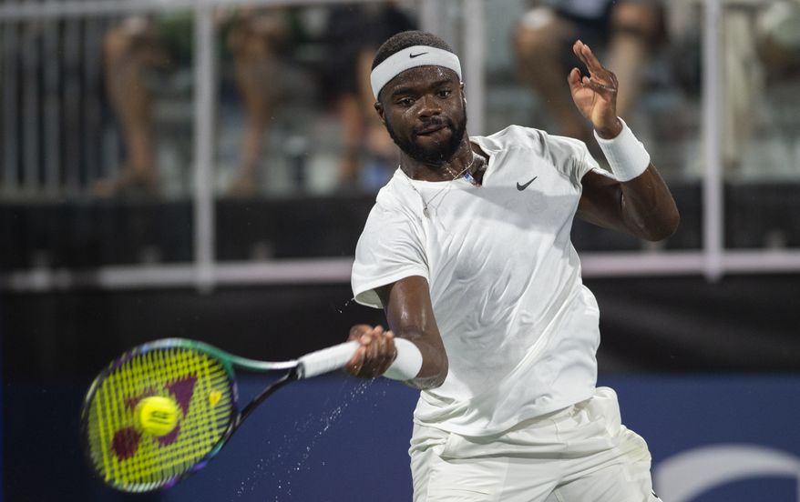 Frances Tiafoe, of the United States, returns the ball to countryman Jenson Brooksby during a semifinal at the Atlanta Open tennis tournament Saturday, July 30, 2022, in Atlanta. (AP Photo/Hakim Wright Sr.)