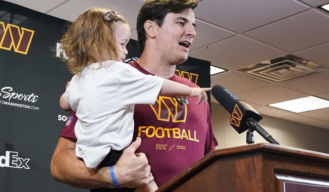 Former Washington player Ryan Kerrigan holds his daughter Hayes Kerrigan as he speaks with reporters about his recent retirement at the Washington Commanders&#x27; NFL football training facility, Saturday, July 30, 2022 in Ashburn, Va. (AP Photo/Alex Brandon)