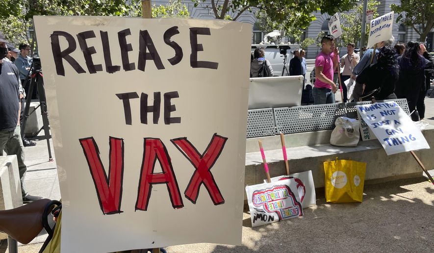 A sign urges the release of the monkeypox vaccine during a protest in San Francisco, July 18, 2022. The mayor of San Francisco announced a legal state of emergency Thursday, July 28, 2022, over the growing number of monkeypox cases. Public health officials warn that moves by rich countries to buy large quantities of monkeypox vaccine, while declining to share doses with Africa, could leave millions of people unprotected against a more dangerous version of the disease and risk continued spillovers of the virus into humans. (AP Photo/Haven Daley, File)