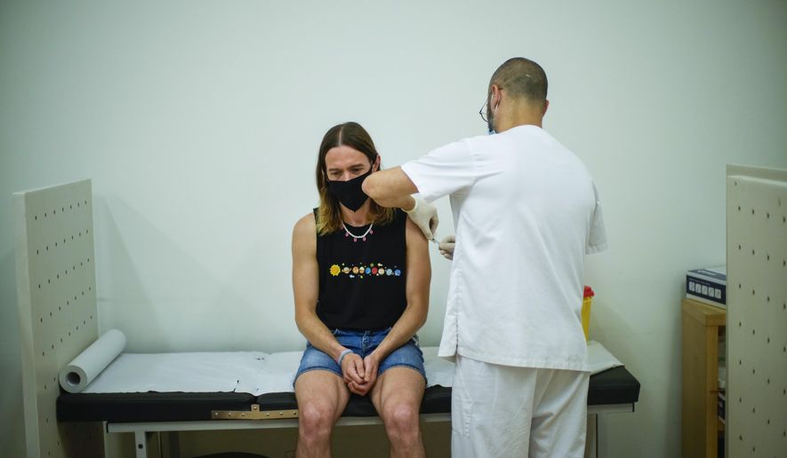 FILE - Daniel Rofin, 41, receives a vaccine against Monkeypox from a health professional in medical center in Barcelona, Spain, Tuesday, July 26, 2022. Public health officials warn that moves by rich countries to buy large quantities of monkeypox vaccine, while declining to share doses with Africa, could leave millions of people unprotected against a more dangerous version of the disease and risk continued spillovers of the virus into humans. (AP Photo/Francisco Seco, File)