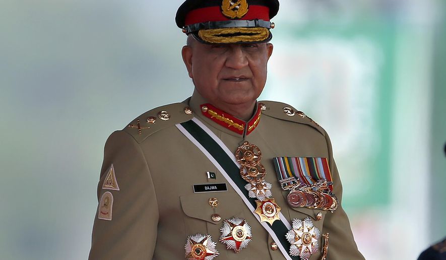 FILE - Pakistan&#x27;s Army Chief General Qamar Javed Bajwa arrive to attend a military parade to mark Pakistan National Day in Islamabad, Pakistan, Wednesday, March 23, 2022. Officials say Pakistan’s powerful army chief in a rare move this week, Saturday, July 30,  contacted Washington, urging U.S. authorities to use their influence to secure an early release of a key $1.7 billion installment from the International Monetary Fund. The latest development comes as Islamabad struggles to stave off a deepening economic crisis.  (AP Photo/Anjum Naveed, File)