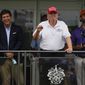 U.S. Rep. Marjorie Taylor Greene, left, Tucker Carlson, center, and former President Donald Trump watch golfers on the 16th tee during the final round of the Bedminster Invitational LIV Golf tournament in Bedminster, N.J., Sunday, July 31, 2022. (AP Photo/Seth Wenig)